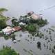A farm house is surrounded by floodwaters in the town of Bli Bli on February 27, 2022.
